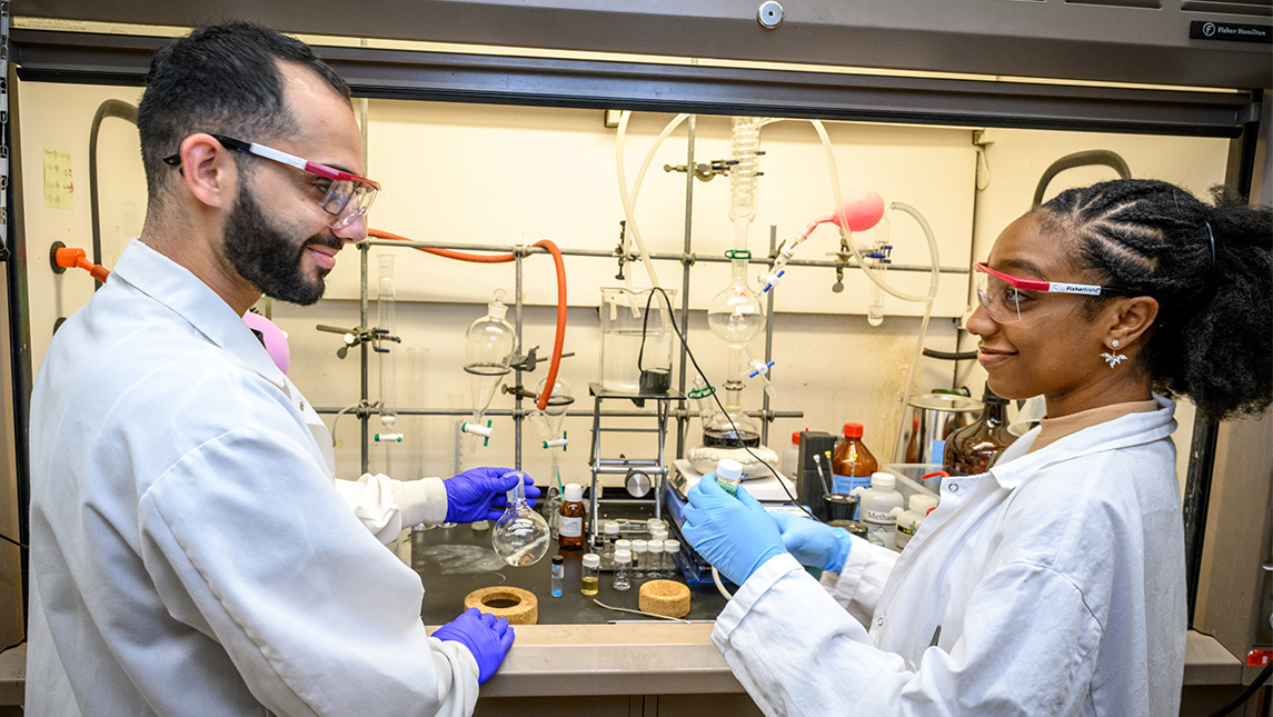 Two students work in a UNCG chemistry lab.