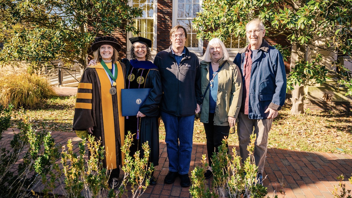 Kim Vogt poses with her family after graduating with a PhD for School of Nursing.