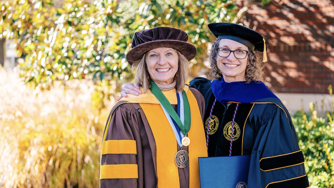 Kim Vogt poses with head of nursing program after graduating with a PhD for School of Nursing.