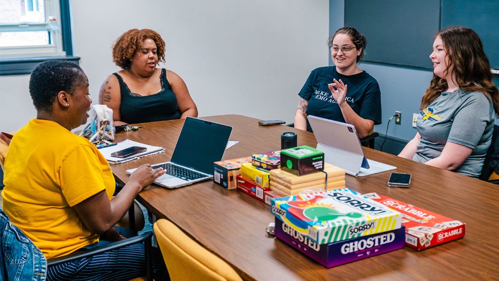 UNCG students in the Foster Forward organization talk at a table.