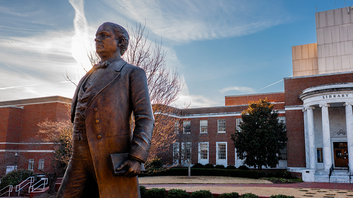 McIver statue in front of the UNCG library on a sunny day.