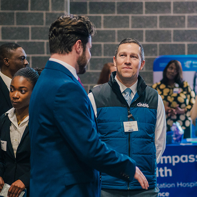 Student speaks with a recruiter at the career fair.