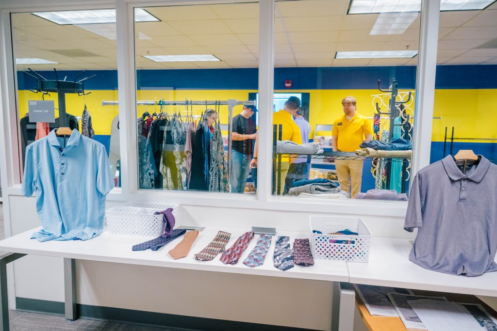 Windows at the CPD suite show racks of clothes and business attire on display.