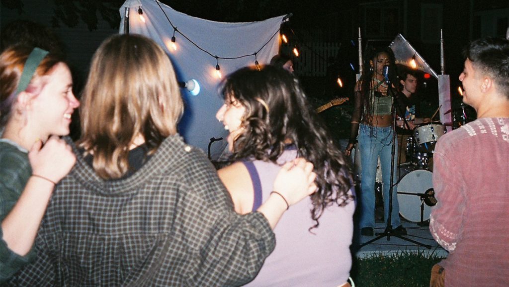 Guests listen to music in backyard of Doggie House.